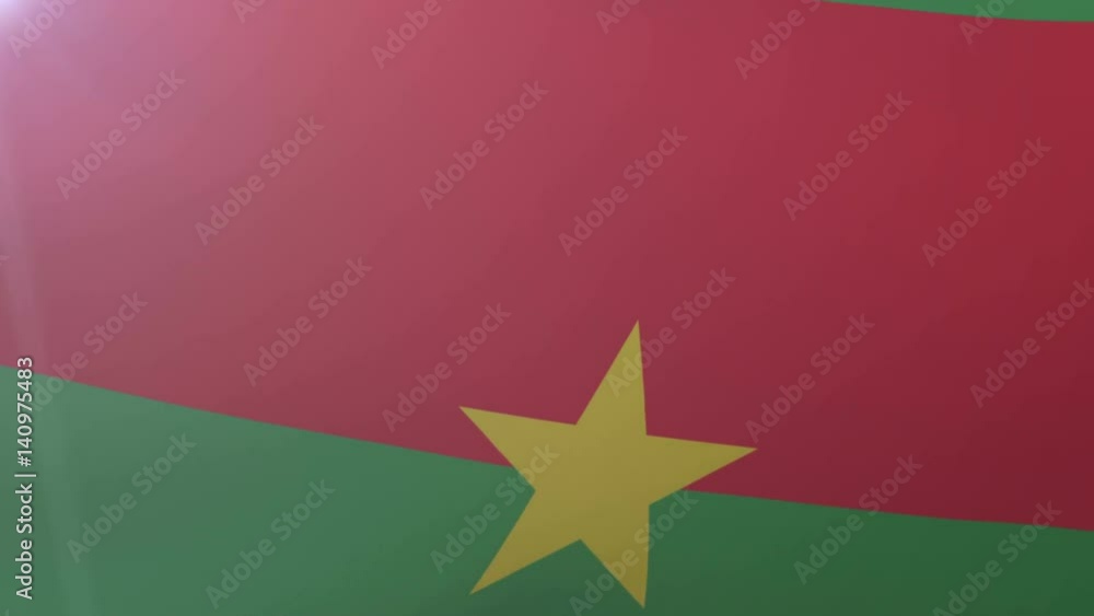 Flag of Burkina Faso waving on flagpole in the wind, national symbol of freedom Flag of Burkina Faso waving on flagpole in the wind, national symbol of freedom