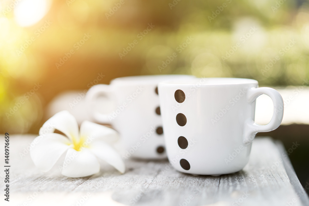Coffee or tea cup on table and green bokeh with bright sunlight background Coffee or tea cup on table and green bokeh with bright sunlight background