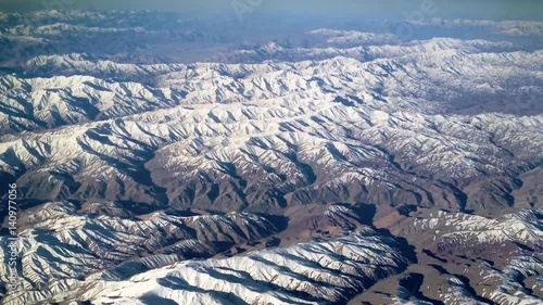 Slow flyover mountains southwest of Kabul, Afghanistan. Camera mounted to lighter-than-air ship (dirigible). Slow graceful pan over rugged landscape & caves where Taliban & Al-Qaeda terrorists hide. photo