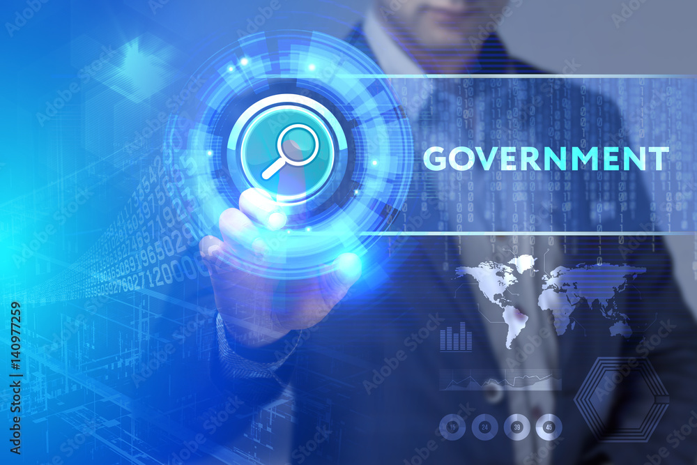 Business, Technology, Internet and network concept. Business man working on the tablet of the future, select on the virtual display: Government Business, Technology, Internet and network concept. Business man working on the tablet of the future, select on the virtual display: Government