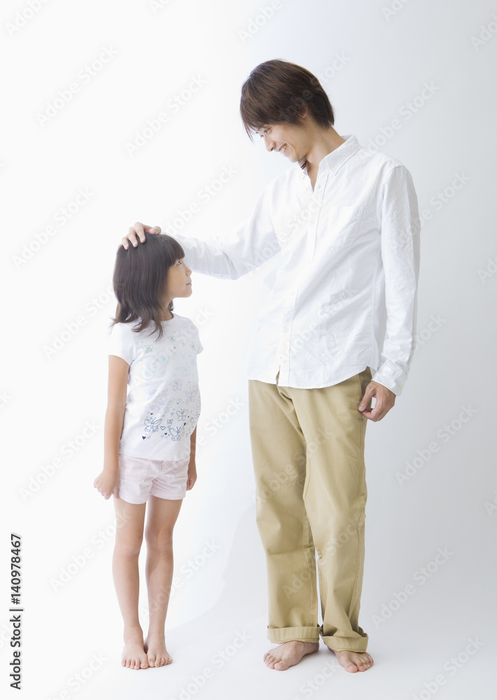 Father and daughter standing side by side Father and daughter standing side by side