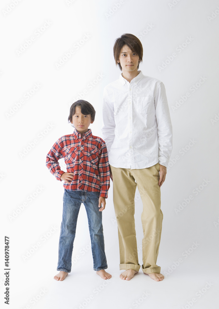Father and son standing side by side Father and son standing side by side