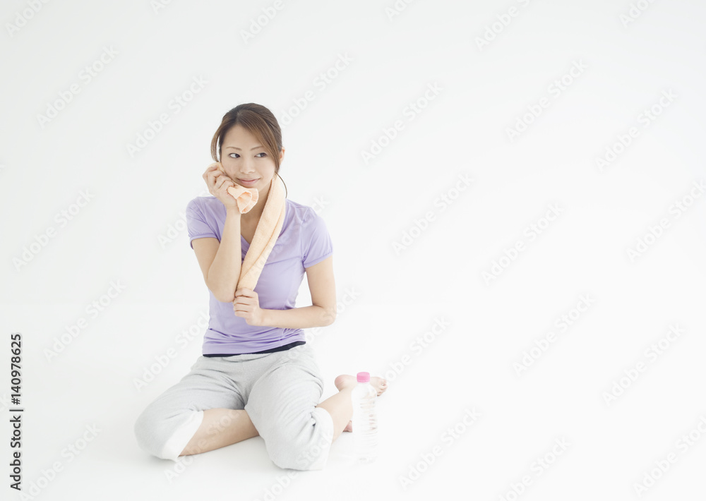 Young woman wiping sweat Young woman wiping sweat