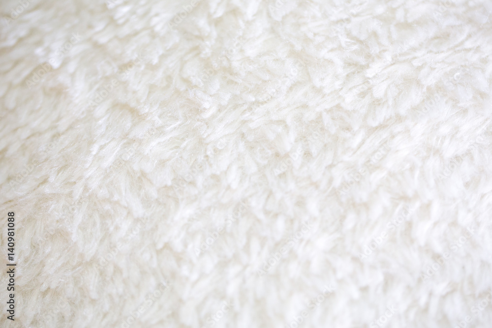 Smooth, soft and flurry white carpeting material texture.