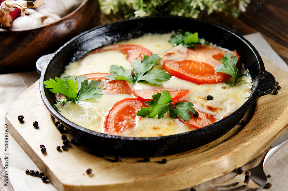 Beef tongue baked with potatoes in creamy sauce with cheese and tomatoes Beef tongue baked with potatoes in creamy sauce with cheese and tomatoes