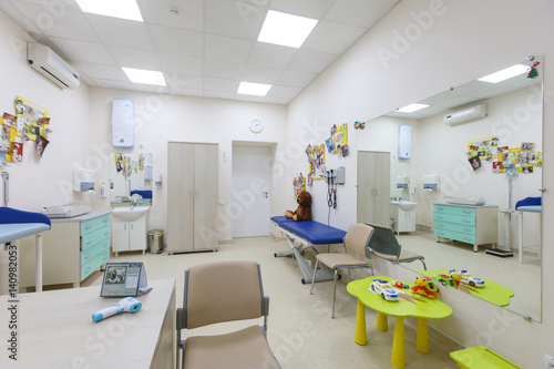 A pediatrician s office in a blue and white interior.