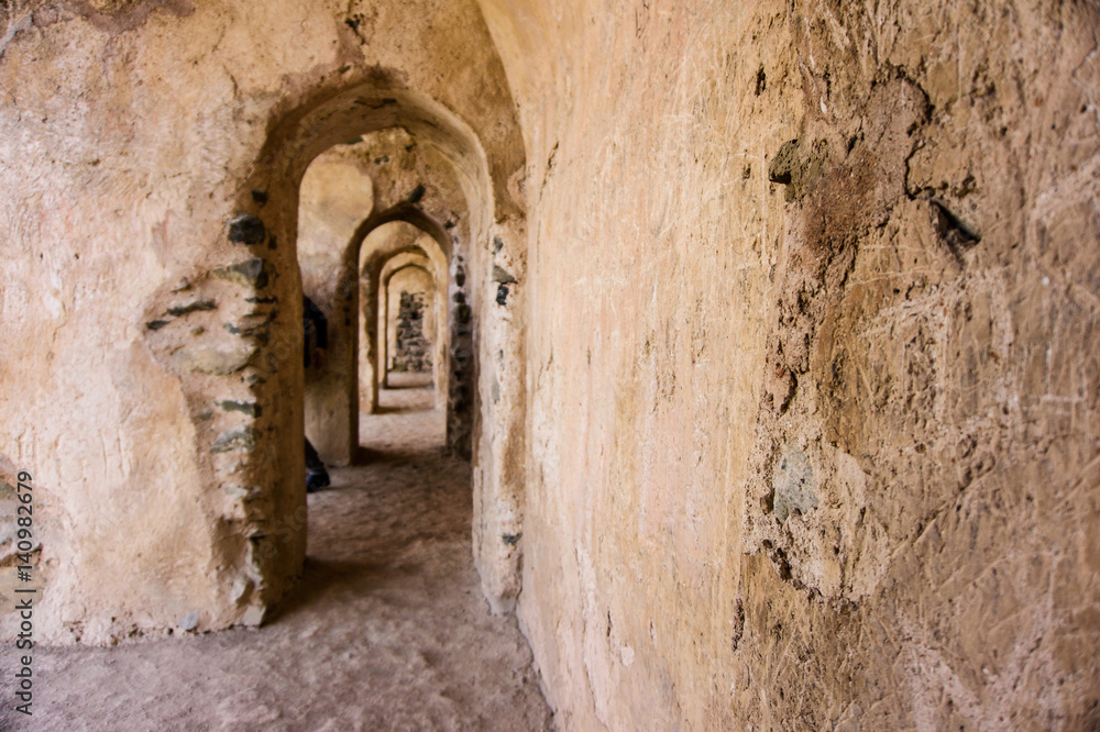 Ancient stone wall and tunnel with archways
