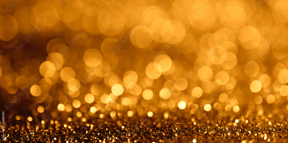 Abstract glitter bokeh light on golden background wide fan page panorama format.