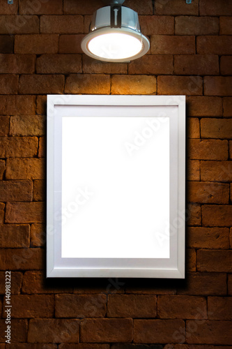 photo frame on brick wall with single light lamp