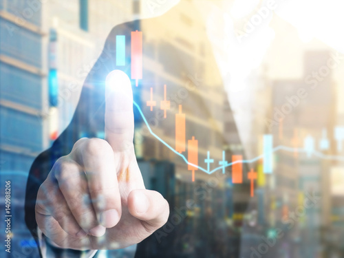 Double exposure of businessman with Trading graph on the cityscape background,Business financial concept