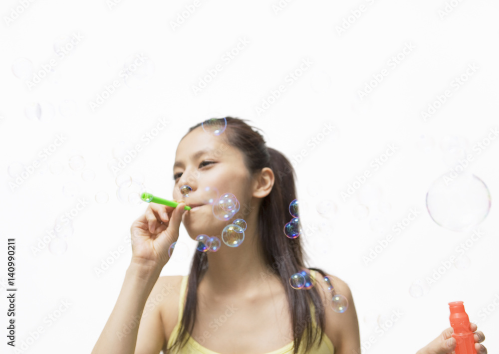 Young woman playing with soap bubble Young woman playing with soap bubble