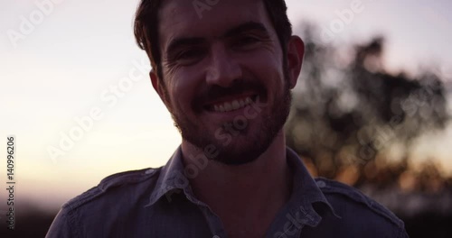 Close up, man with beard smiles at camera, slow motion