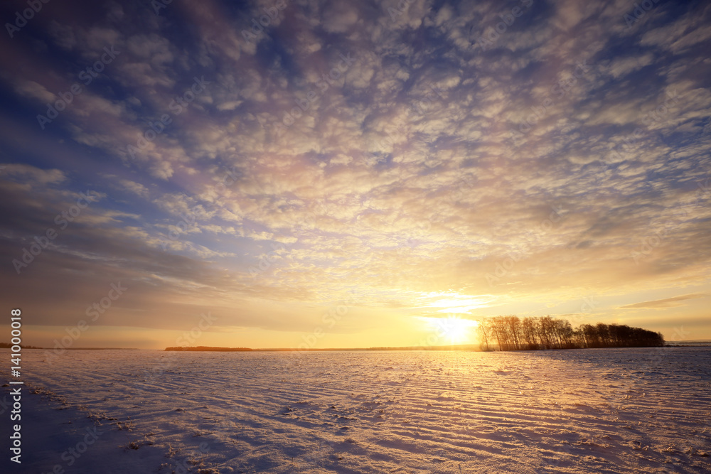 colorful sunrise over the snow-covered field