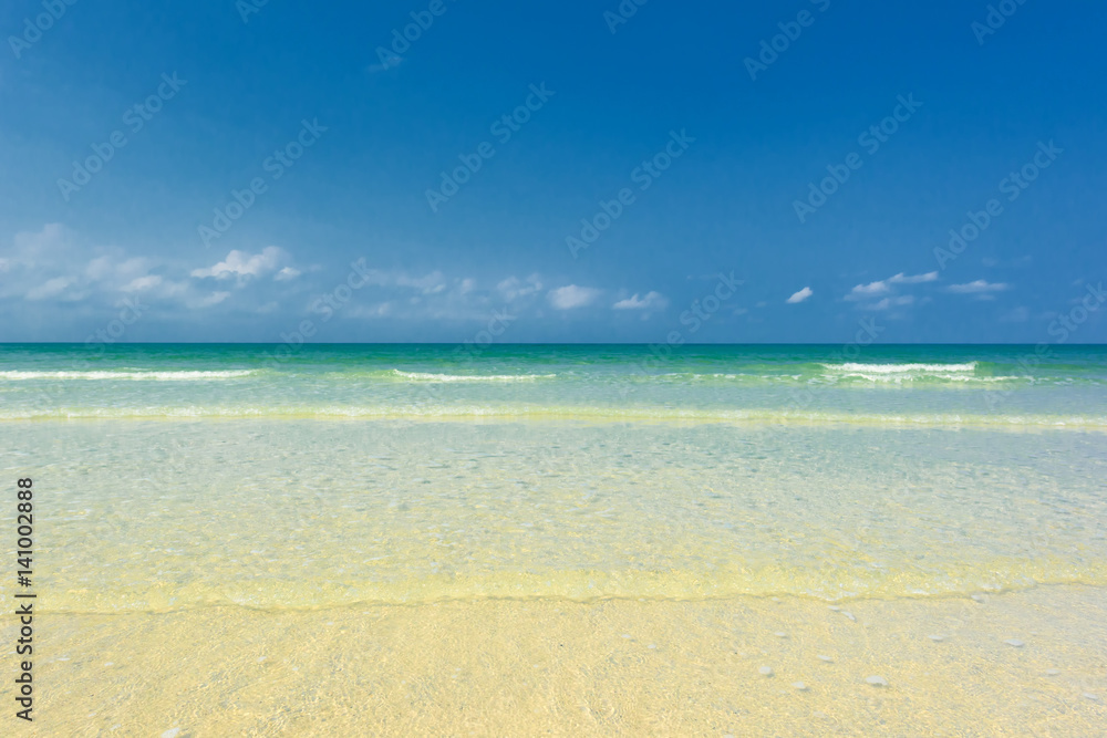 Beautiful gentle wave at the shallow beach with blue sky