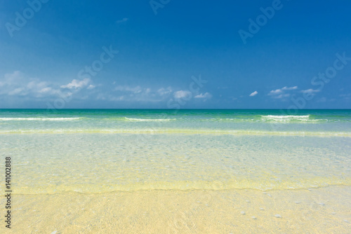 Fototapeta Naklejka Na Ścianę i Meble -  Beautiful gentle wave at the shallow beach with blue sky