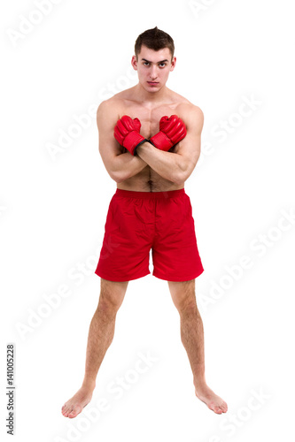 Full length portrait of young male boxer showing some movements against isolated white background