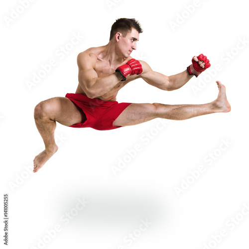 Full length portrait of young male boxer showing some movements against isolated white background