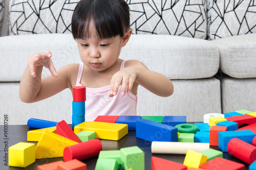 Asian Chinese little girl playing building blocks at home photo