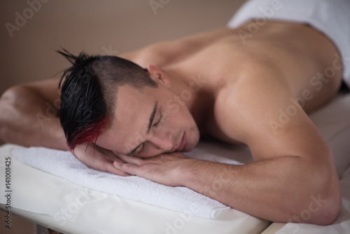 handsome man resting in a spa massage center