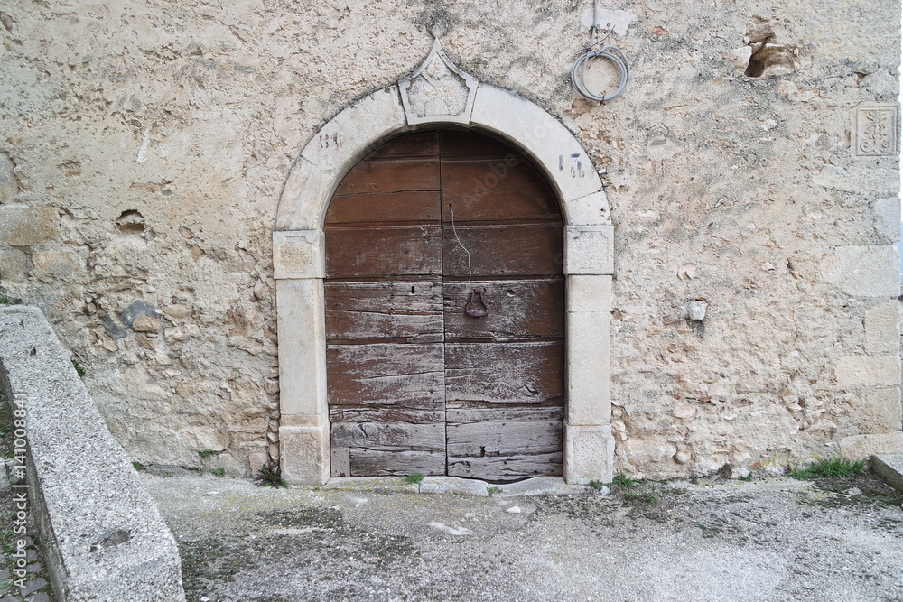 old and stone arched wooden door           