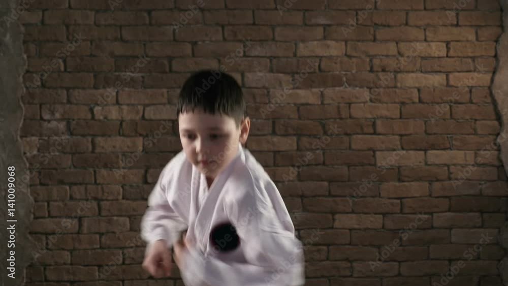 A seven year old sportsman practices a karate kata in studio A seven year old sportsman practices a karate kata in studio