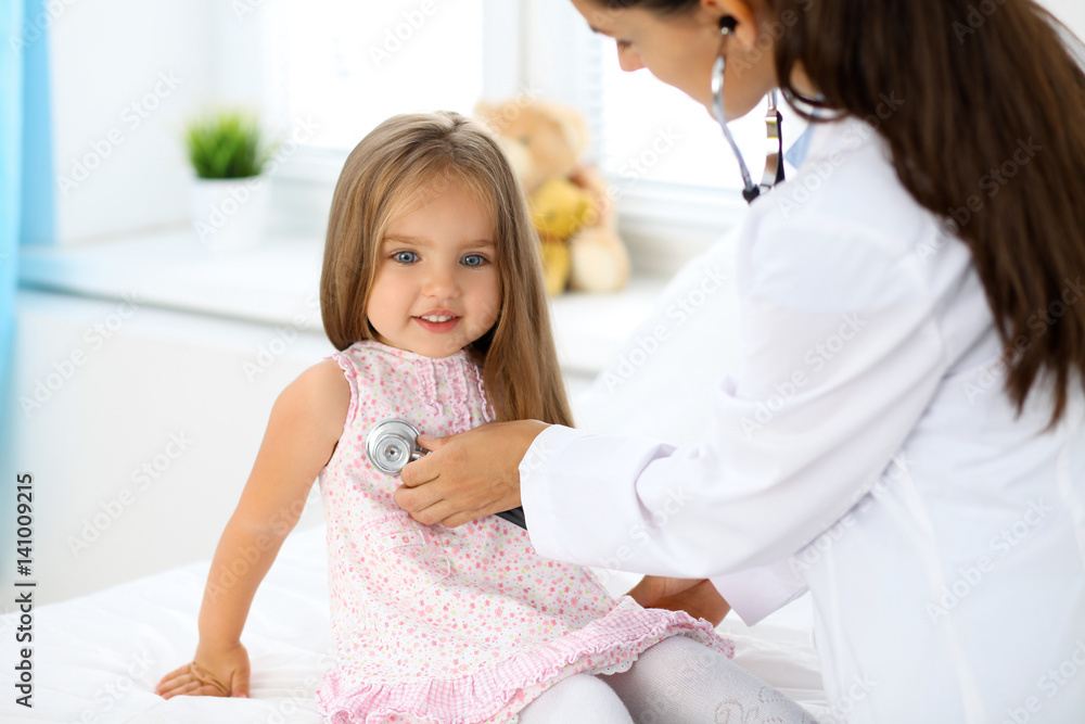Doctor examining a little girl by stethoscope Doctor examining a little girl by stethoscope