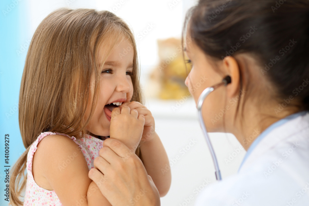 Doctor examining a little girl by stethoscope Doctor examining a little girl by stethoscope
