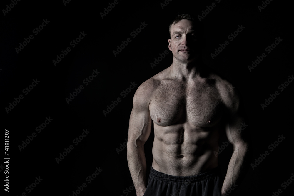 handsome bodybuilder man with muscular body training in gym