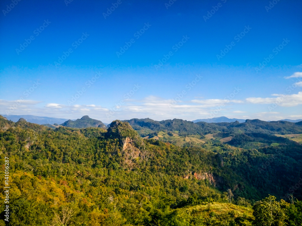Beautiful green mountain and peak with blue sky backgrounds