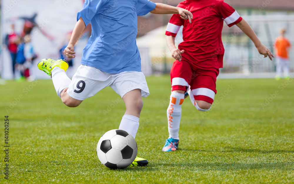 Football Soccer Match for Children. Kids Playing Soccer Game Tournament. Boys Running and Kicking Football on the Sports Grass Field Football Soccer Match for Children. Kids Playing Soccer Game Tournament. Boys Running and Kicking Football on the Sports Grass Field