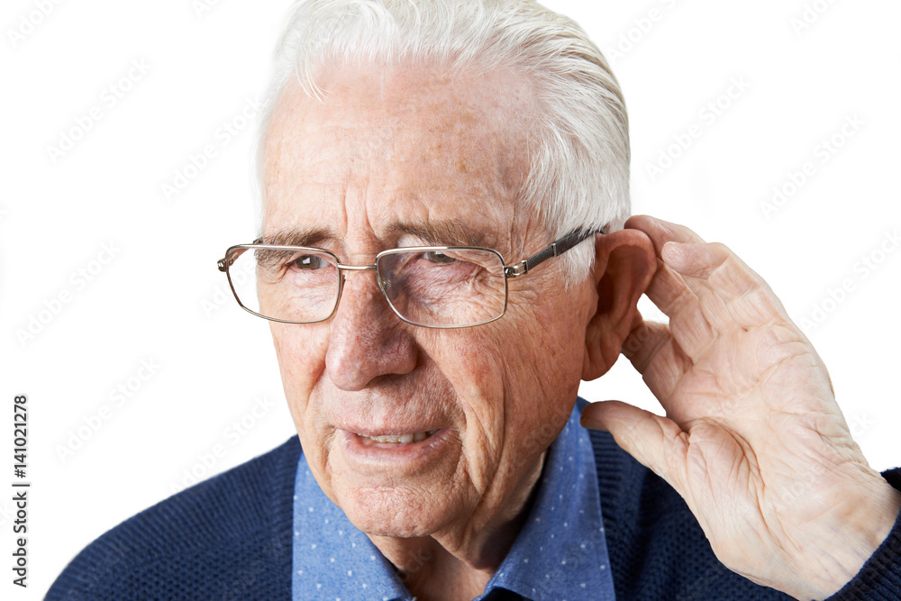 Studio Shot Of Senior Man Suffering From Deafness Studio Shot Of Senior Man Suffering From Deafness