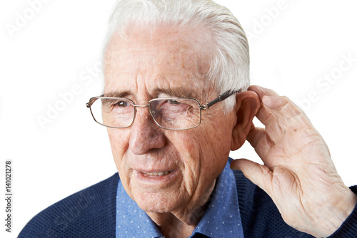 Studio Shot Of  Senior Man Suffering From Deafness photo