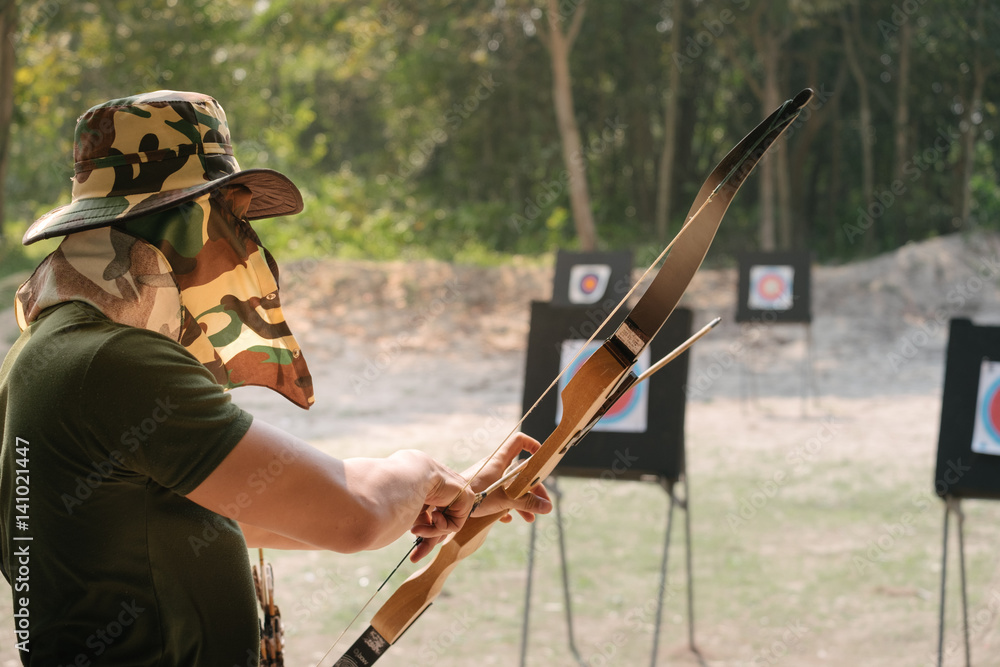 Fototapeta premium Asian Male Soldier training with the arror and bow