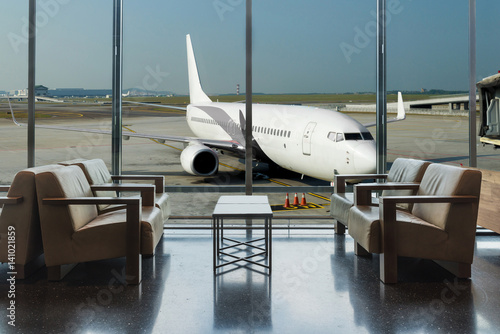 Airplane view from airport lounge in airport terminal.