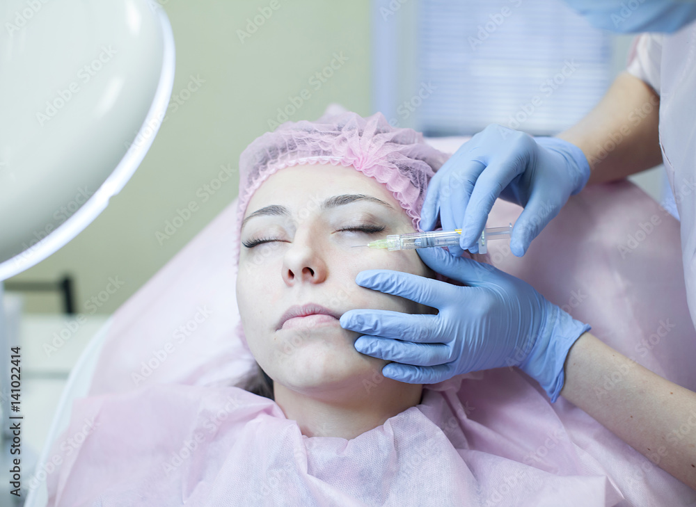 Naklejka premium Cosmetic treatment with injection in a clinic