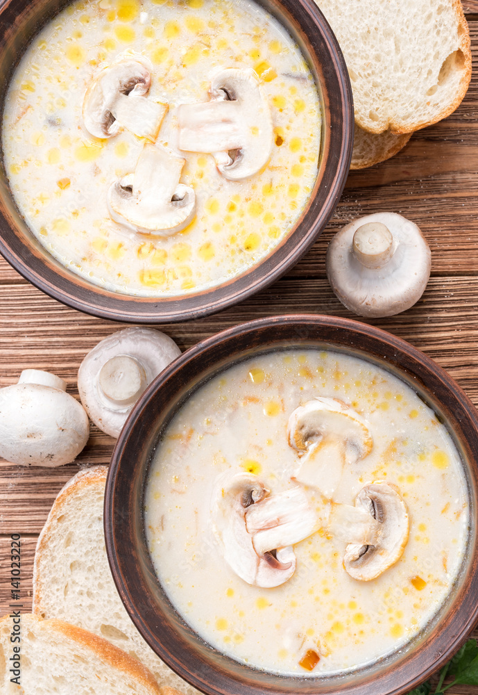 Mushroom soup on a rustic wooden background . Mushroom soup on a rustic wooden background .