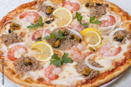 Delicious fresh pizza with seafood on white background, horizontal