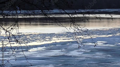 Time laps of the spring ice drift on the river. Beautiful landscape of nature awakening - ice on melting ice floes on the water in a swift stream.