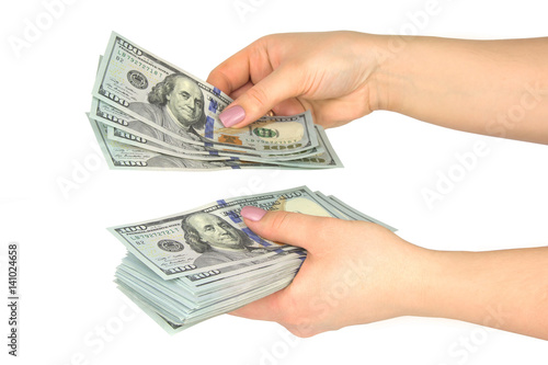 Female hands consider dollars on a white background