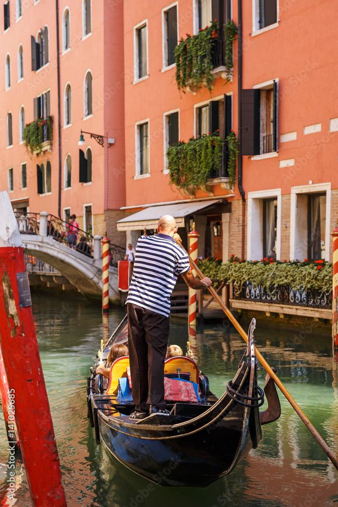 Traditional Gondolas on a narrow canal in Venice, beautiful romantic italian city