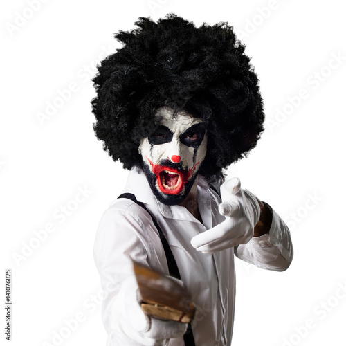 Killer clown with knife shouting © luismolinero
