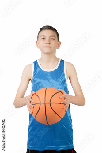 Young caucasian teenage boy with a basketball