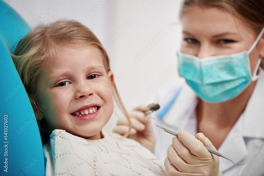 Small girl curing teeth in dentist office. Concept of milk tooth inspection and treatment. Small girl curing teeth in dentist office. Concept of milk tooth inspection and treatment.