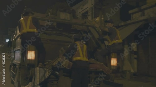Wallpaper Mural Workers are moving on a garbage truck at night Torontodigital.ca