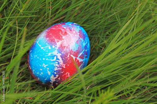 Colored easter egg on green grass