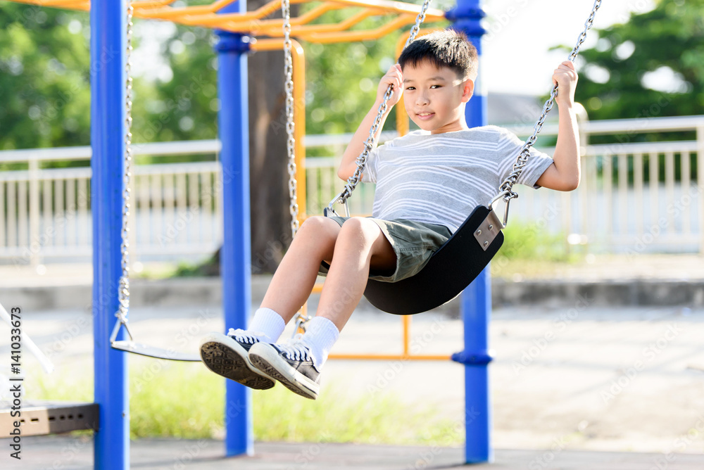 Fototapeta premium Asian boy play with swinging. with swinging.