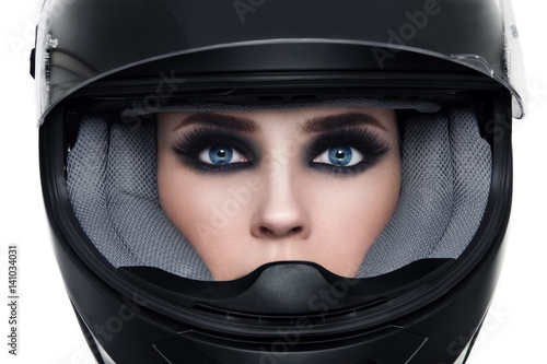 Close-up portrait of young beautiful woman in biker helmet over white background © Olga Ekaterincheva