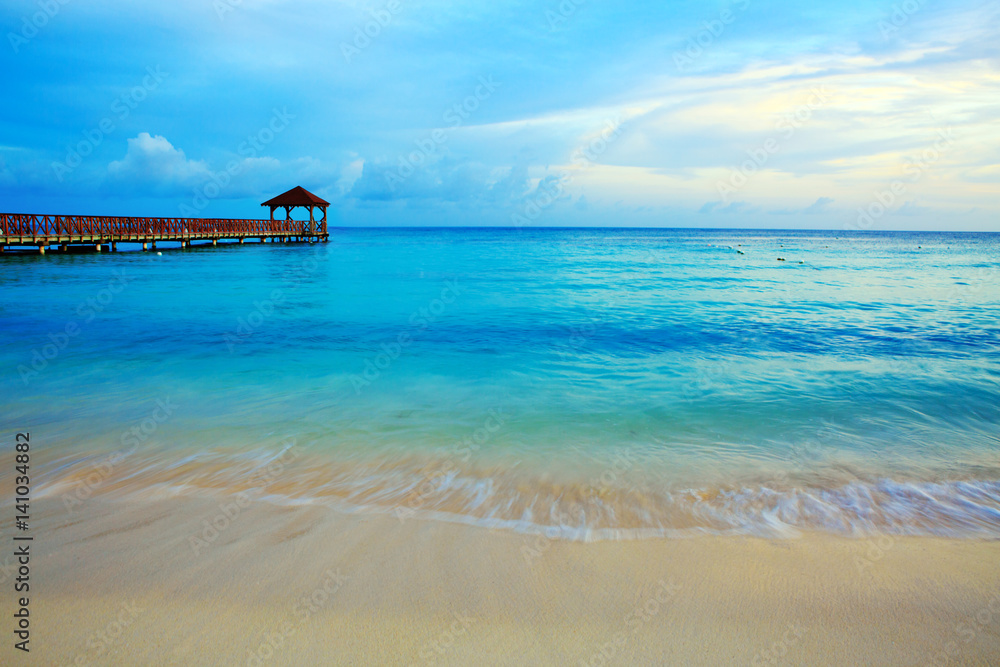Beach of caribbean sea and wooden pier . Beach of caribbean sea and wooden pier .