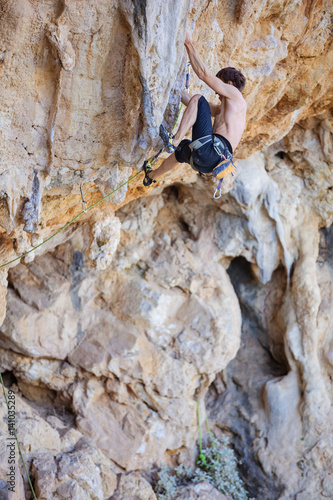 Male rock climber on cliff