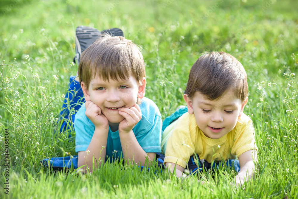 Happy kid enjoying sunny late summer and autumn day in nature on green grass. Happy kid enjoying sunny late summer and autumn day in nature on green grass.